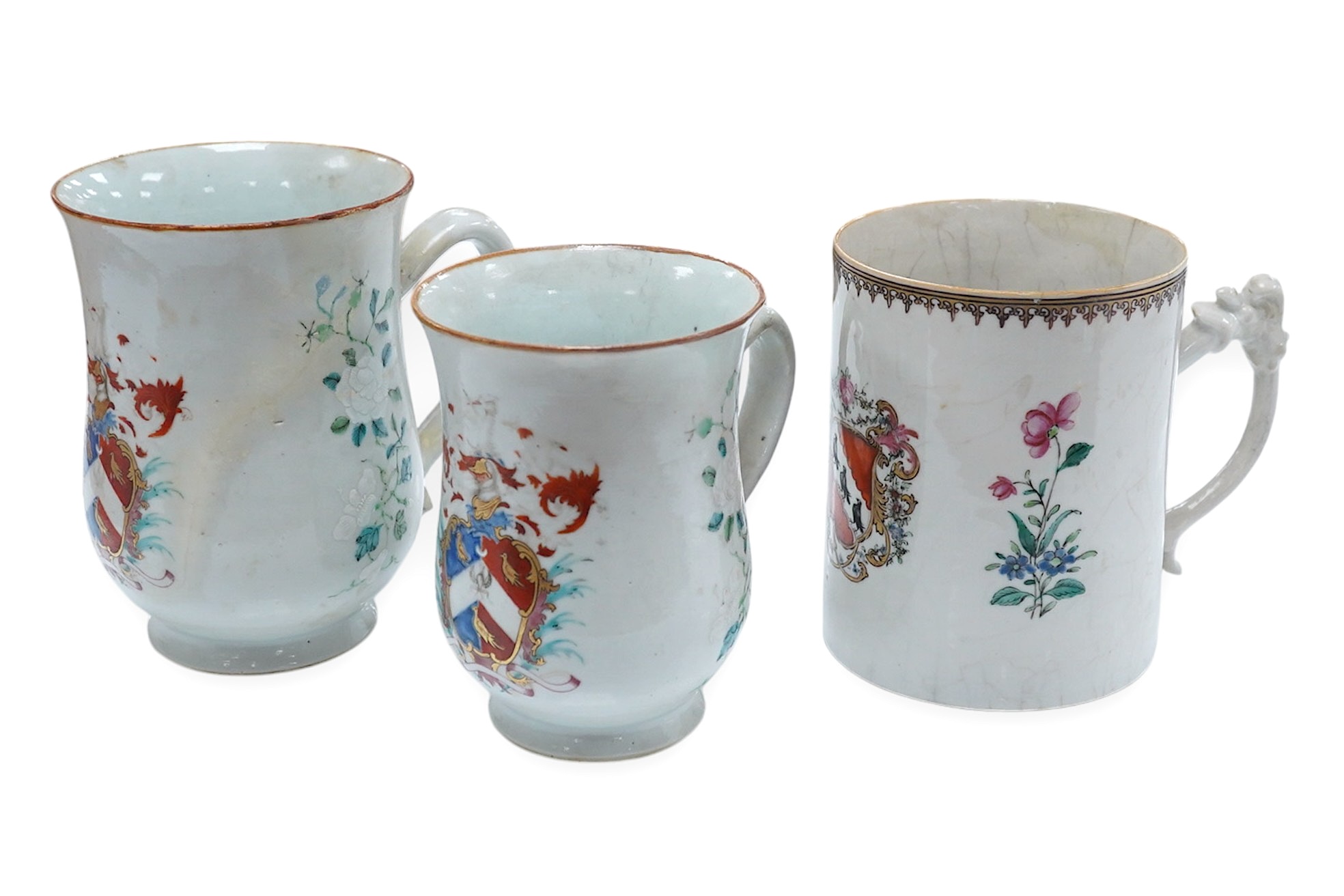 Three 18th century Chinese export armorial mugs, largest 14cm high. Condition - all restored